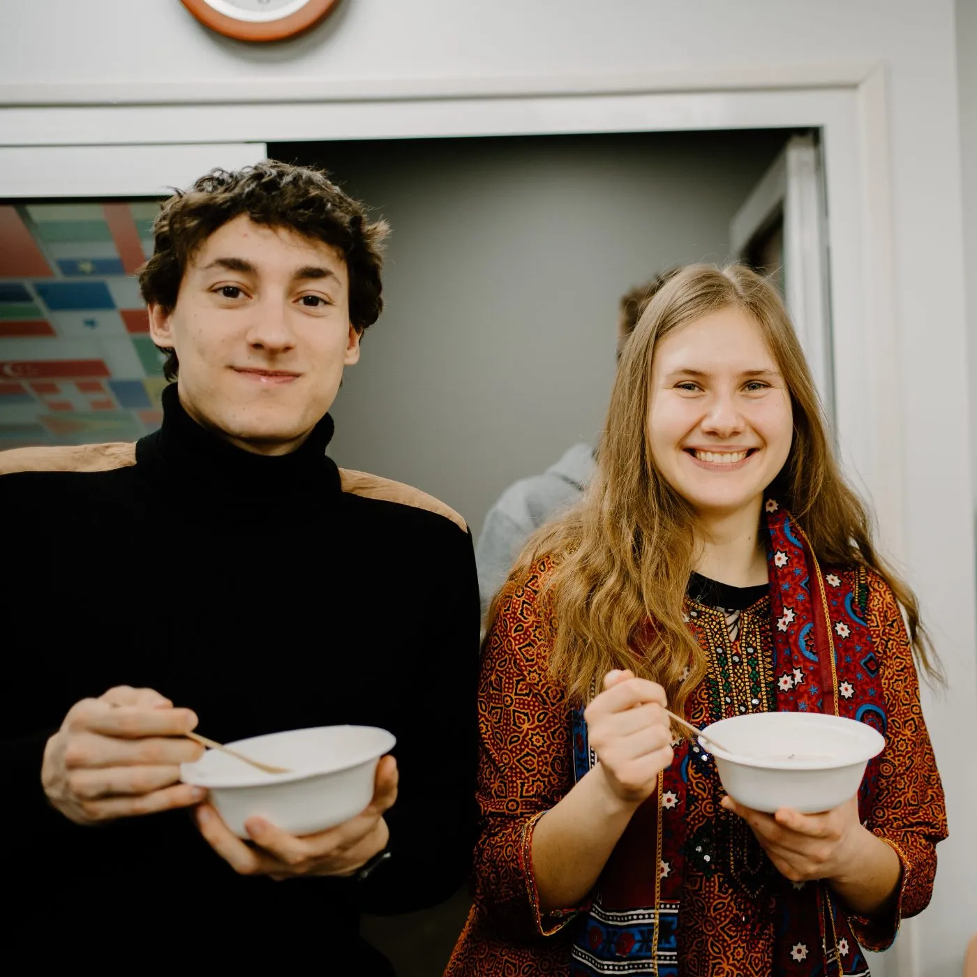 Two students enjoying soup at a social speaking event