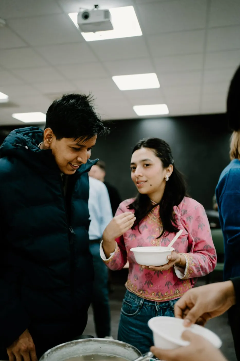 Students sharing food at a social speaking event