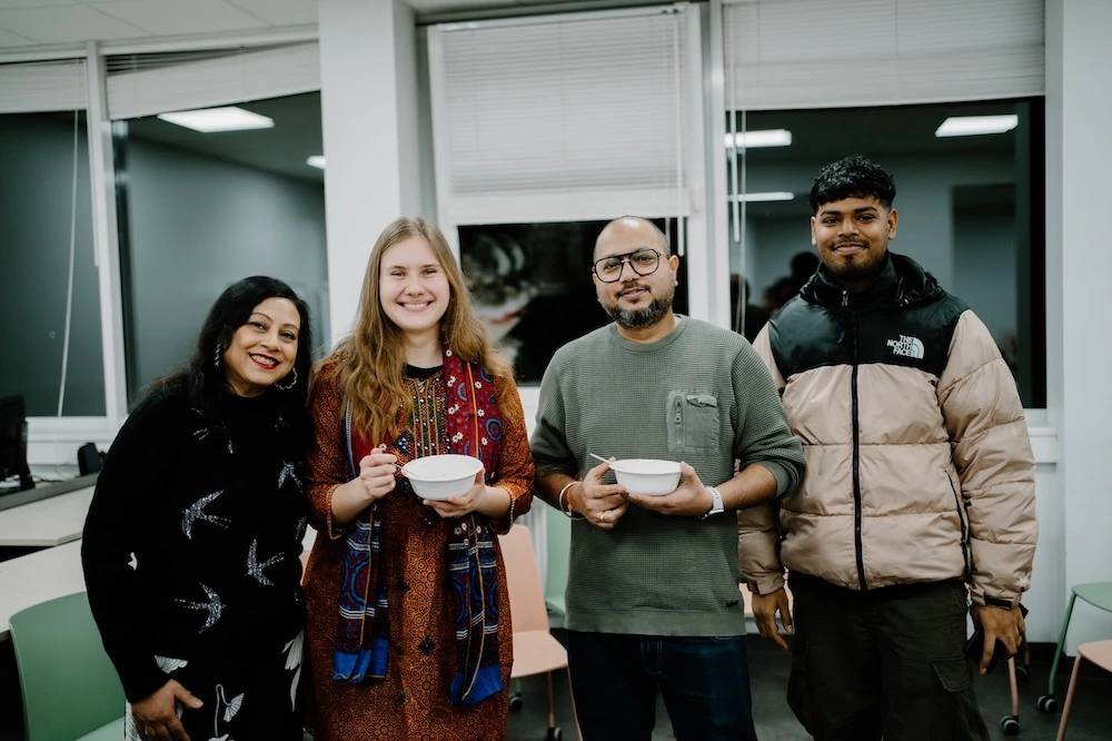 Students sharing traditional food at a social speaking event